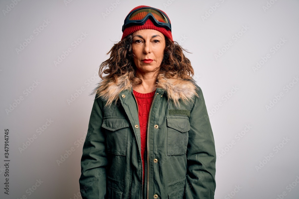 Middle age skier woman wearing snow sportswear and ski goggles over white background depressed and worry for distress, crying angry and afraid. Sad expression. Middle age skier woman wearing snow sportswear and ski goggles over white background depressed and worry for distress, crying angry and afraid. Sad expression.