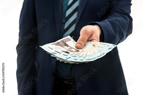 Wallpaper Mural businessman gives bribe or pay, in isolation. UAH. 1000 new banknote Ukrainian money Torontodigital.ca