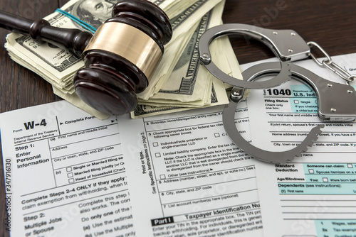 tax form concept us money with handcuffs gavel lying on Federal Tax.