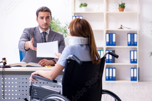 Young injured woman and male lawyer in the courtroom photo