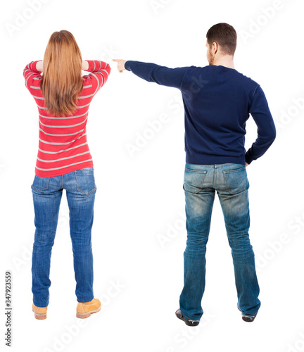 Back view of couple in sweater pointing.