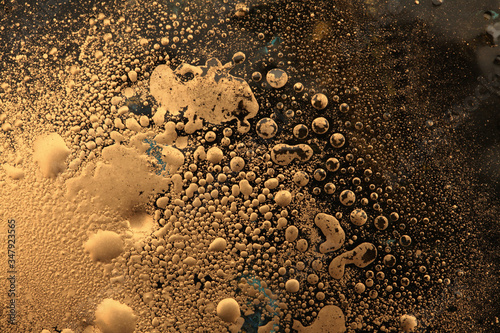 Macro black and gold Abstract bubble drop texture background. Acrylic color in water and oil. photo