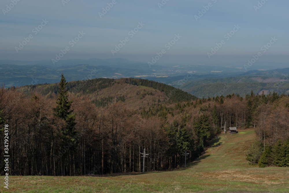 Ski slope with ski tow near Radhost hill in spring sunny day Ski slope with ski tow near Radhost hill in spring sunny day