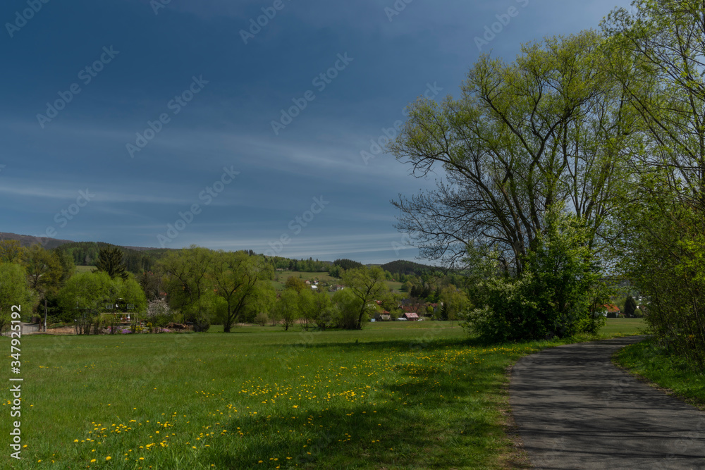 Naklejka premium Dolni Becva village in spring color fresh green day with church and meadows