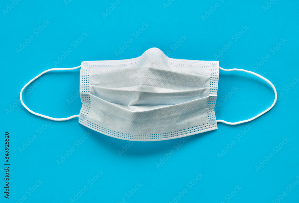 Surgical mask isolated on a light blue background Surgical mask isolated on a light blue background