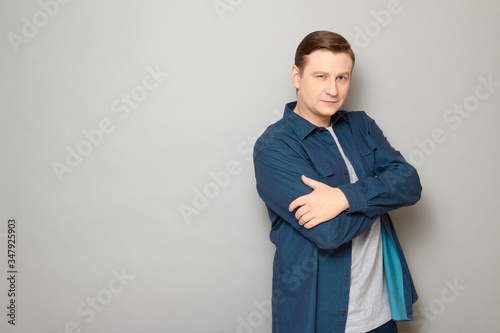 Portrait of focused confident mature man holding arms crossed on chest