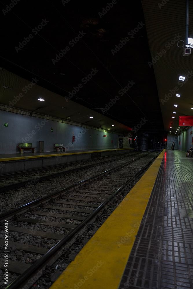 Almost empty underground train station. Platform without passengers.