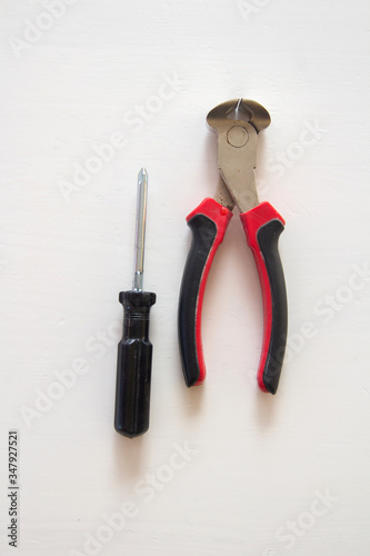 Male tools. Happy Father's Day inscription with screwdriver, Mechanic hand hold spanner tool, pliers on white background. Greetings and presents. white card with the ability to insert text, copyspace