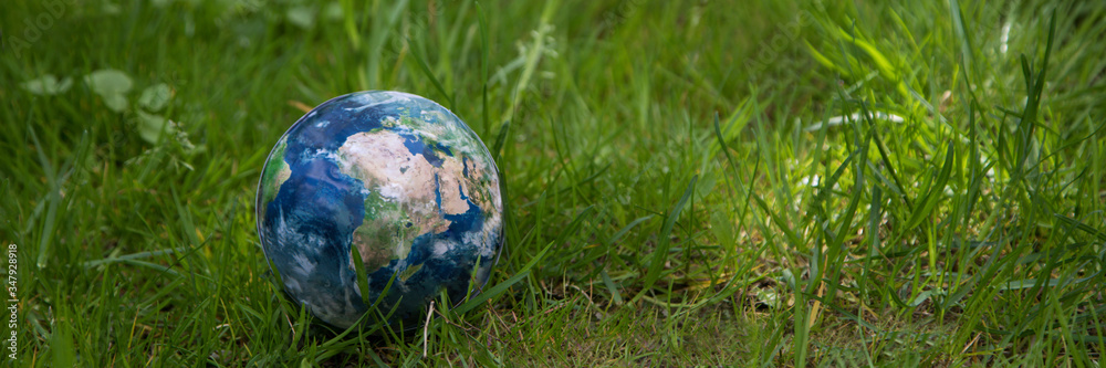 Globe lies on green grass. Concept - Earth Day. Globe lies on green grass. Concept - Earth Day.
