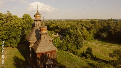 Traditional orhtodox wooden church. Aerial view of historical village with church. Meadieval lifestyle concept. photo