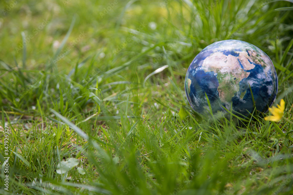 Globe lies on green grass. Concept - Earth Day. Globe lies on green grass. Concept - Earth Day.