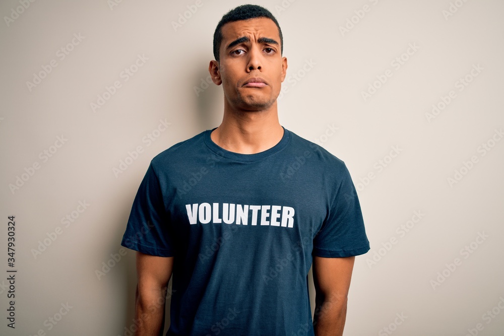 Young handsome african american man volunteering wearing t-shirt with volunteer message depressed and worry for distress, crying angry and afraid. Sad expression. Young handsome african american man volunteering wearing t-shirt with volunteer message depressed and worry for distress, crying angry and afraid. Sad expression.