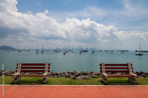 View of boats anchored in the Panama bay with the modern town on the background (Panama city).