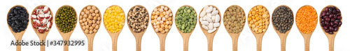 Collection of legumes in wooden spoons on a white background top view. An isolated set of beans, lentils, peas, mung bean, chickpeas. photo