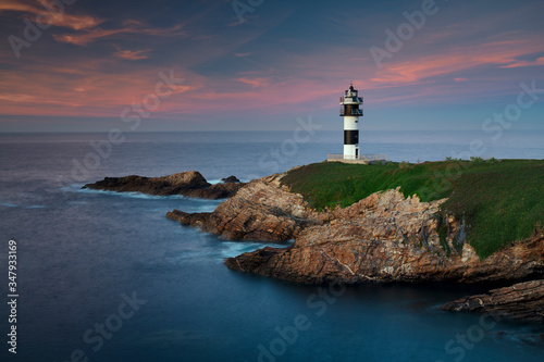 Lighthouse at sunset in Galicia photo
