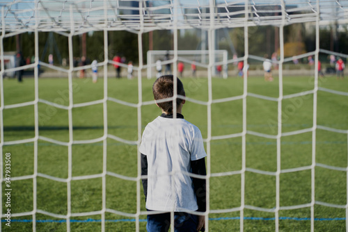 gatekeeper children soccer player in action. stadium photo
