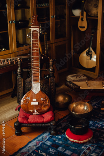 Traditional musical instruments, sitar, cimbalom, singing bowls photo