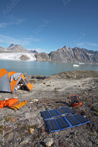 solar panels charging batteries at camping spot in Eastern Greenland photo