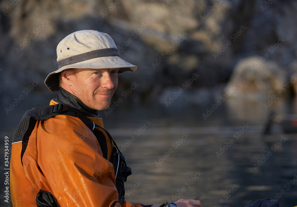 portrait of man on a sea kayak in eastern Greenland portrait of man on a sea kayak in eastern Greenland