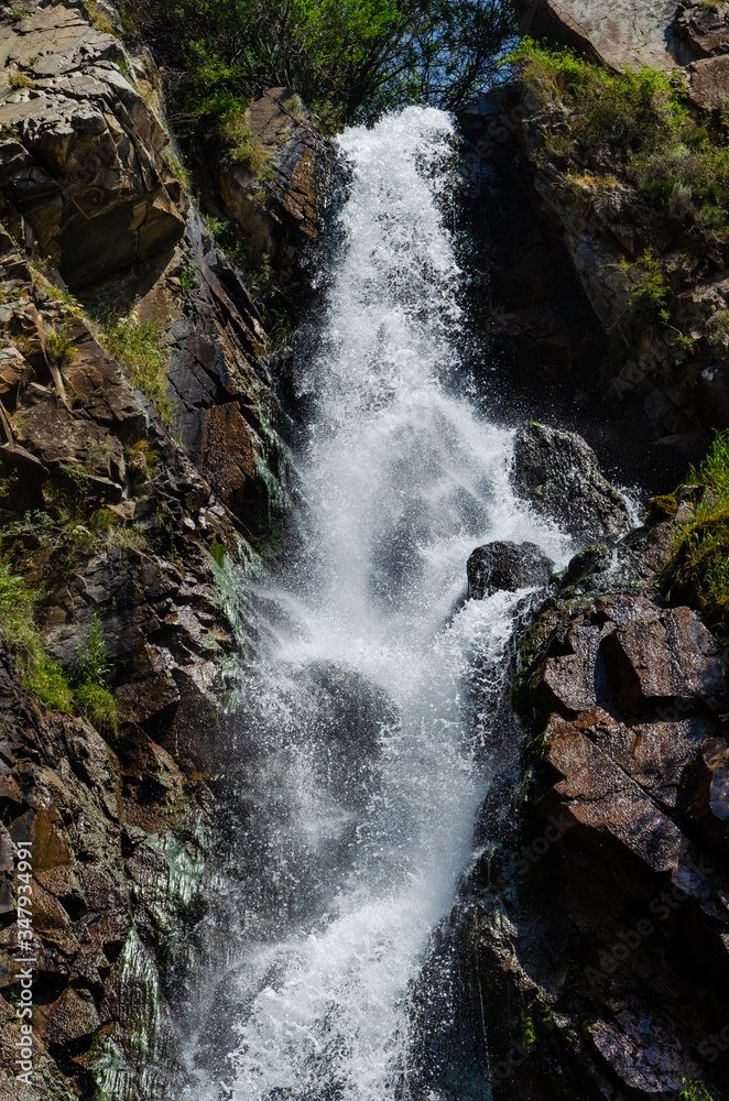 Rocky mountains waterfall in the afternoon short exposure flash