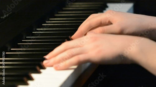 Close up of hands playing the piano