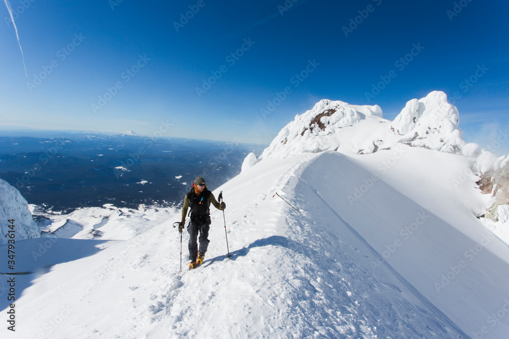 A man climbs to the summit of Mt. Hood in Oregon. A man climbs to the summit of Mt. Hood in Oregon.