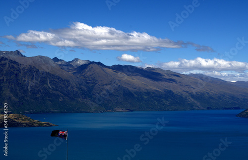 New Zealand Flag against amazing queenstown landscape © Sofia ZA