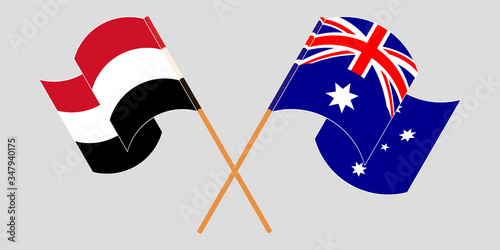 Crossed and waving flags of Yemen and Australia