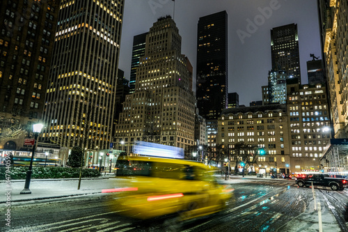 A yelllow cab in new york city at night
