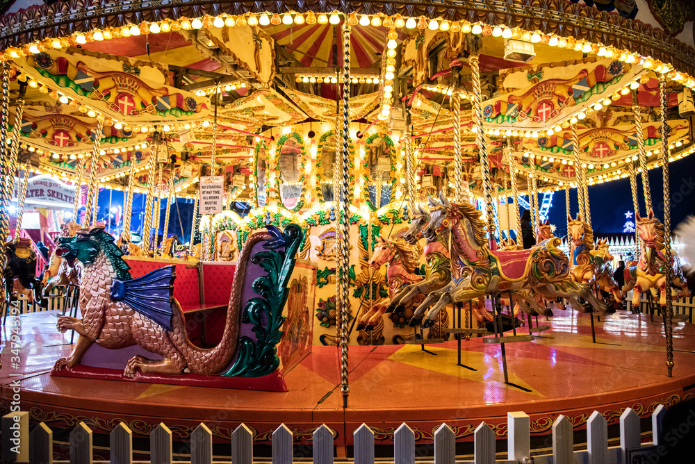 Illuminated bright carousel in amusement park