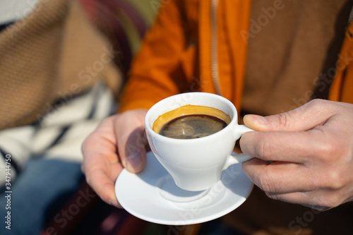 Gentleman holding cup of coffee and saucer