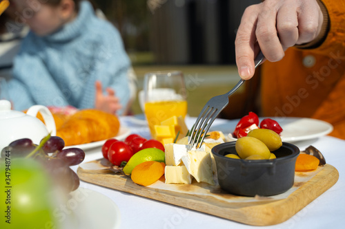 Photos Man impaling piece of cheese with fork