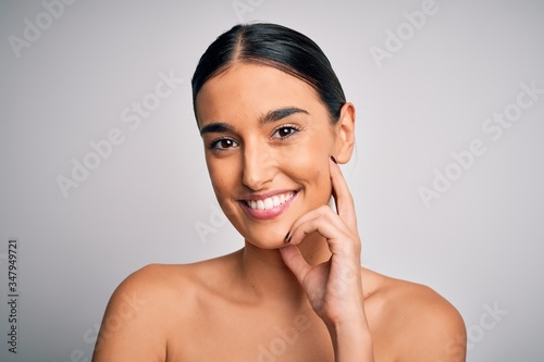 Close up of young beautiful woman with clear and pure skin. Perfect and clean skincare wearing natural makeup. Smiling happy looking fresh and healthy.