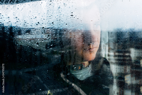 Depressed man looking through window