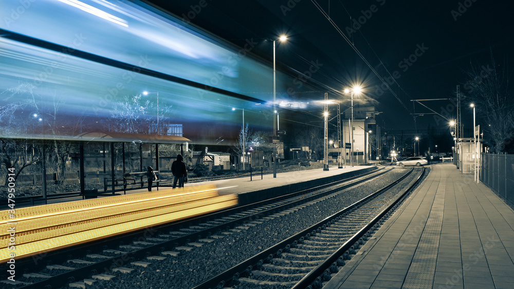 The train passed a railway station, people are waiting on the platform for the next train. The train passed a railway station, people are waiting on the platform for the next train.