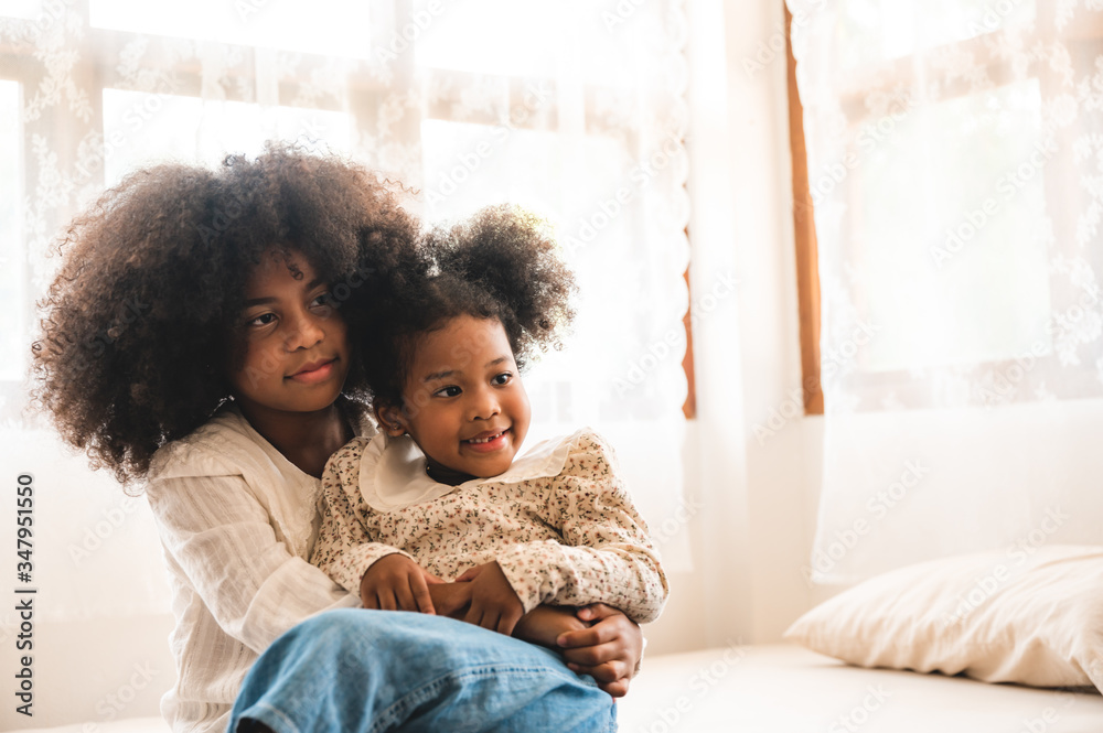 American African children playing on the bed, live at home American African children playing on the bed, live at home