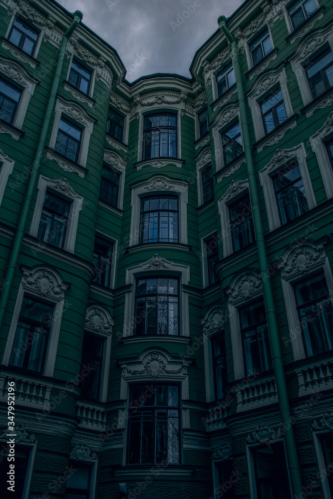 Bottom view of a beautiful green house. The houses of St. Petersburg.Windows of a big city.