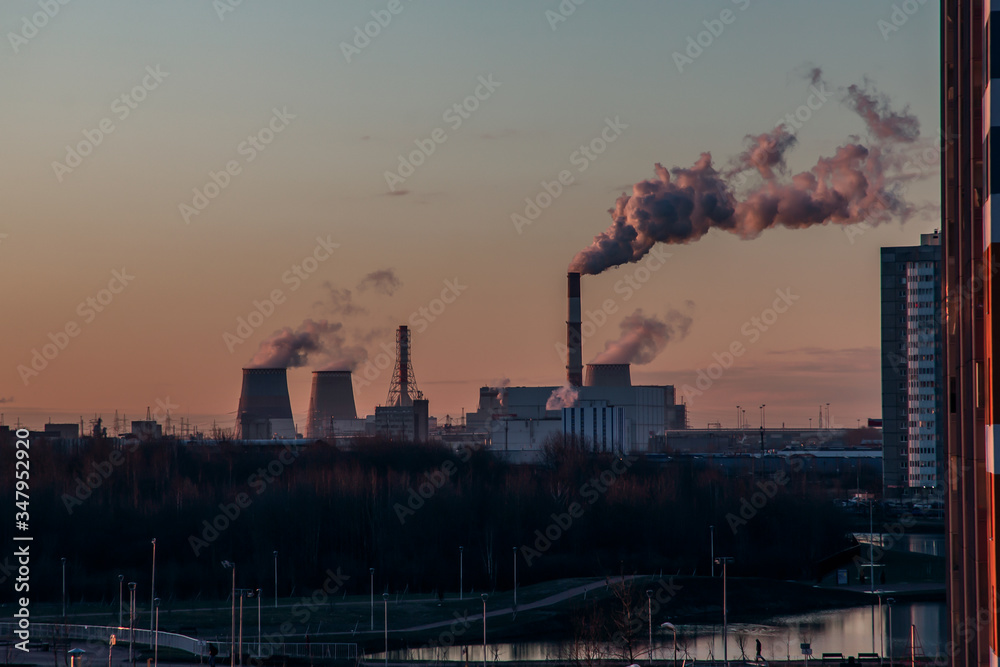 Beautiful sunrise over the chimneys of a thermal power plant. Southern Thermal Power Station St. Petersburg.