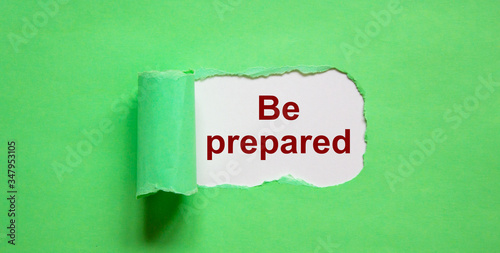The text 'Be prepared' appearing behind torn green paper. Beautiful background, copy space.