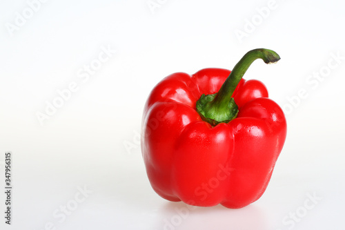 Two red bell peppers isolated on white