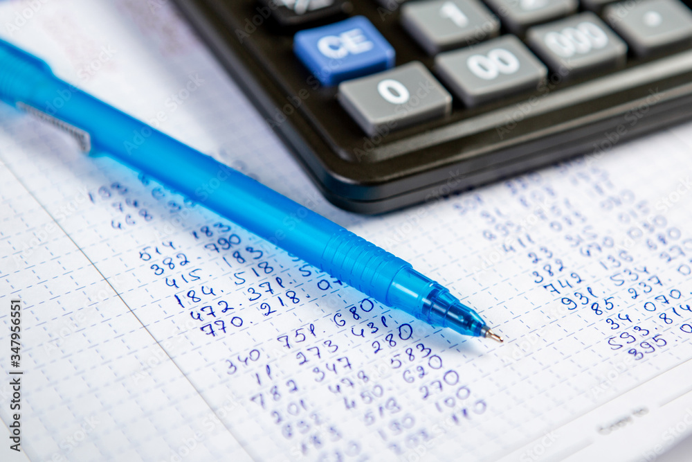 Pen and calculator. Background Items for doing business in the office in the composition. Pen and calculator. Background Items for doing business in the office in the composition.