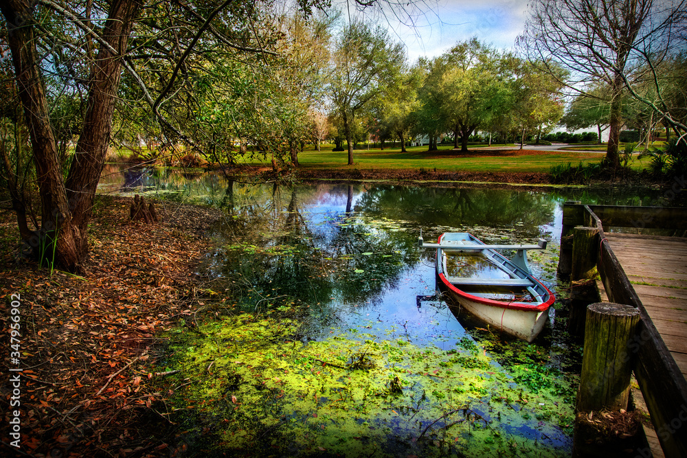 Boat on bayou of Vermillonville historical village Boat on bayou of Vermillonville historical village