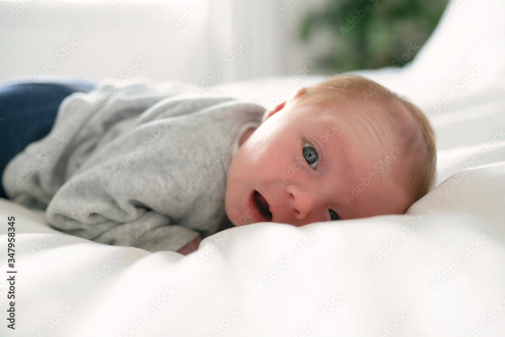 Cute newborn baby girl on the white bed Cute newborn baby girl on the white bed