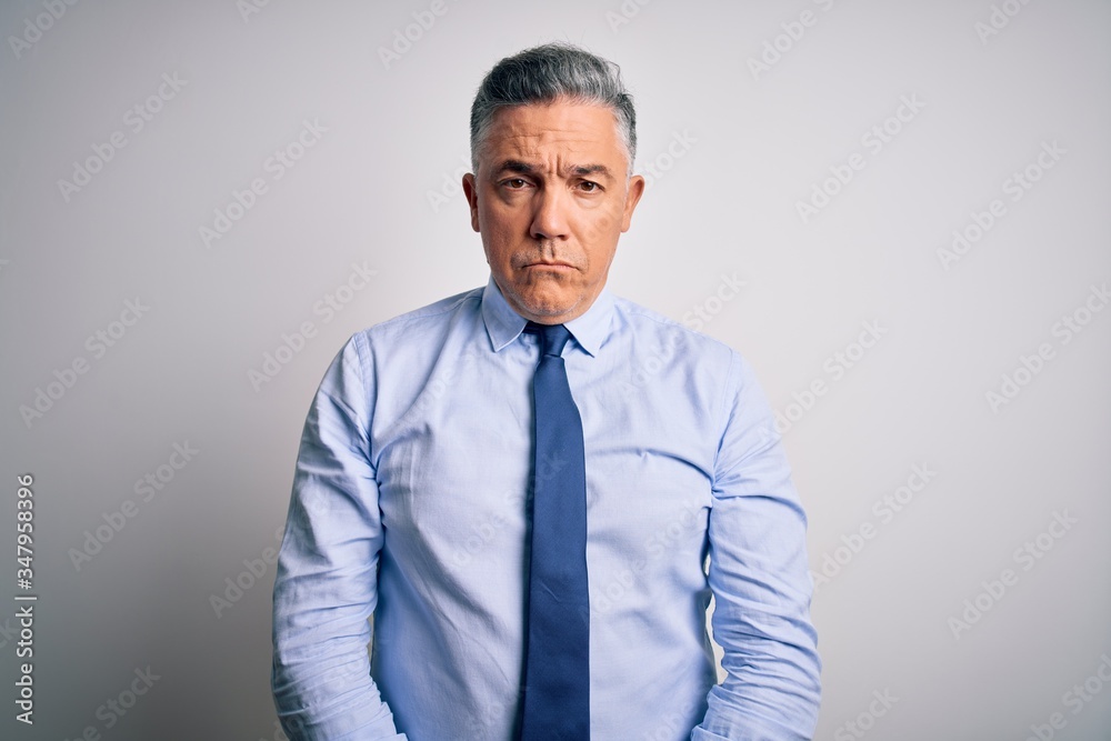Middle age handsome grey-haired business man wearing elegant shirt and tie depressed and worry for distress, crying angry and afraid. Sad expression. Middle age handsome grey-haired business man wearing elegant shirt and tie depressed and worry for distress, crying angry and afraid. Sad expression.