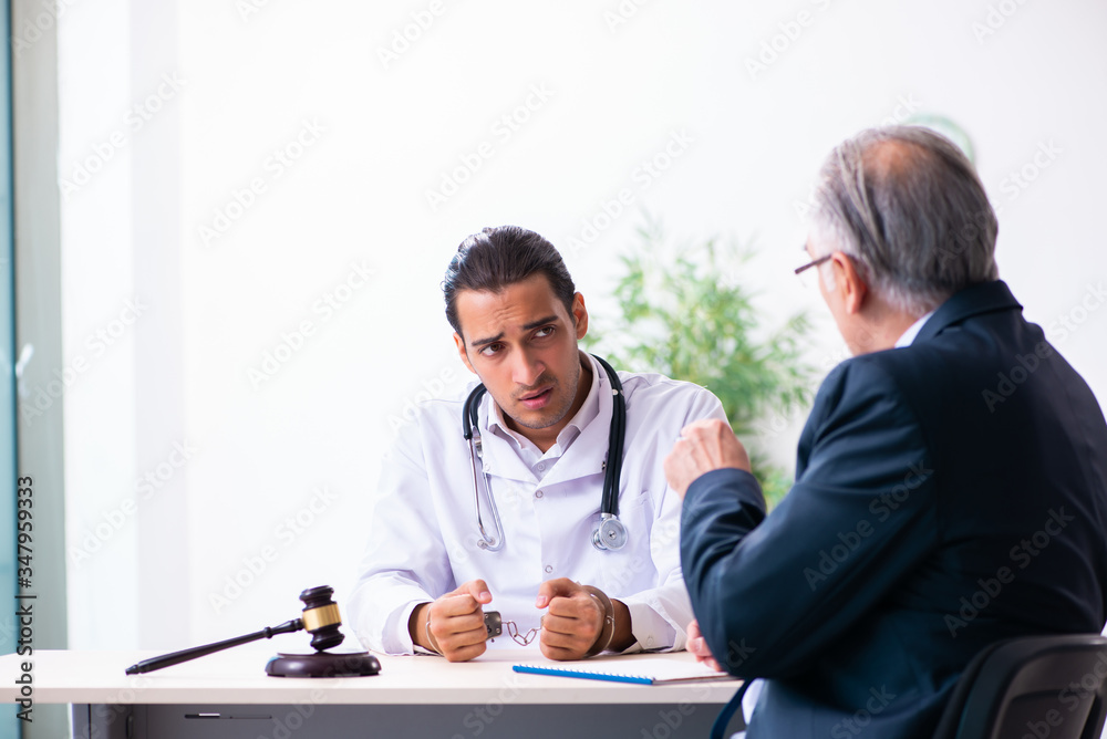 Male doctor in courthouse meeting with lawyer Male doctor in courthouse meeting with lawyer