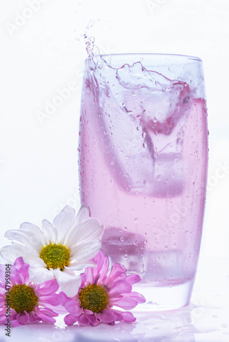 refreshing splash in a pink flavored water glass 