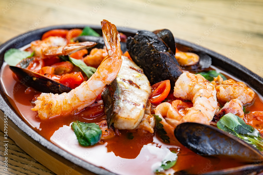 Bowl of seafood, prawns, shrimps, fish, tomatoes Bowl of seafood, prawns, shrimps, fish, tomatoes