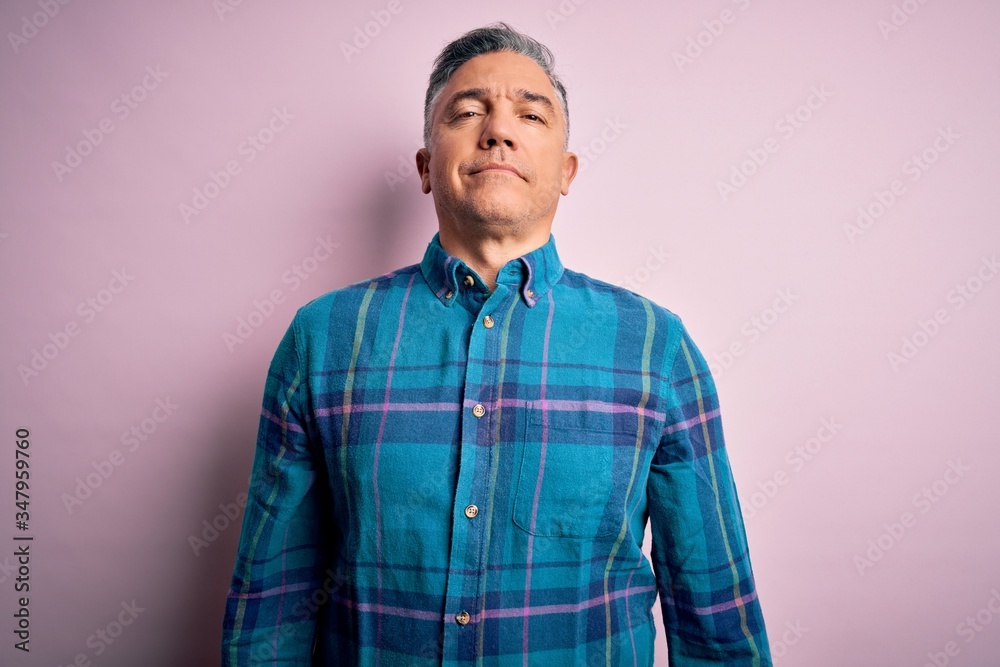 Middle age handsome grey-haired man wearing casual shirt over isolated pink background Relaxed with serious expression on face. Simple and natural looking at the camera. Middle age handsome grey-haired man wearing casual shirt over isolated pink background Relaxed with serious expression on face. Simple and natural looking at the camera.