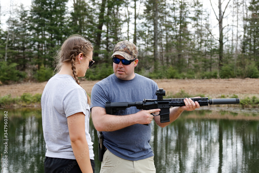 Fototapeta premium Shooting instructor teaching a young woman.