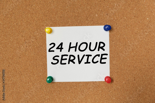 Text 24 HOUR SERVICE written on a sticker photo